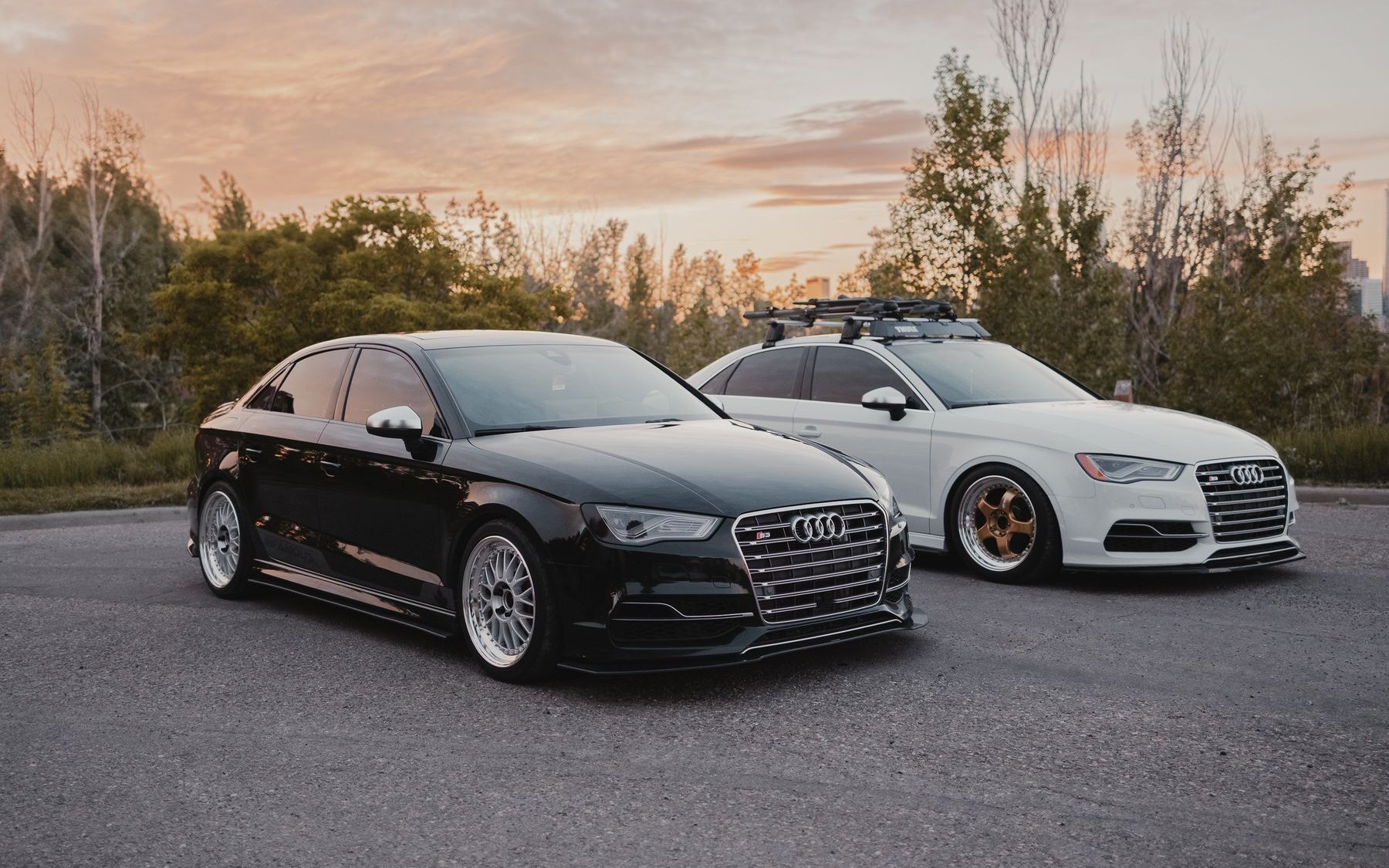 Two lowered Audi S3 8V saloons at sunset